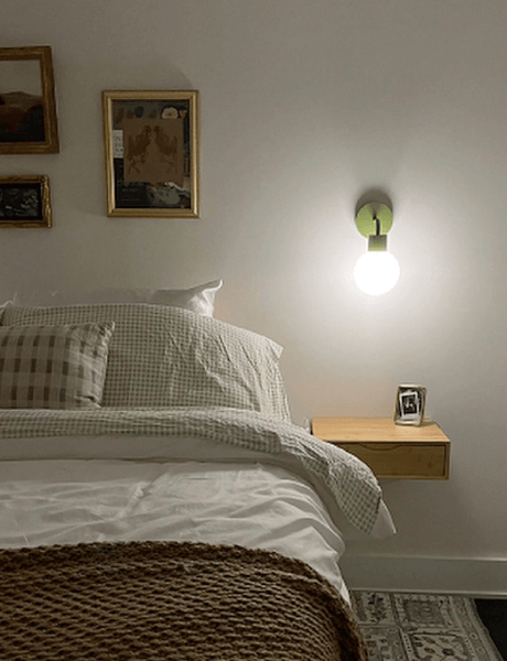 Relaxing bedroom ambient illuminated with PL sage green rechargeable wall sconce