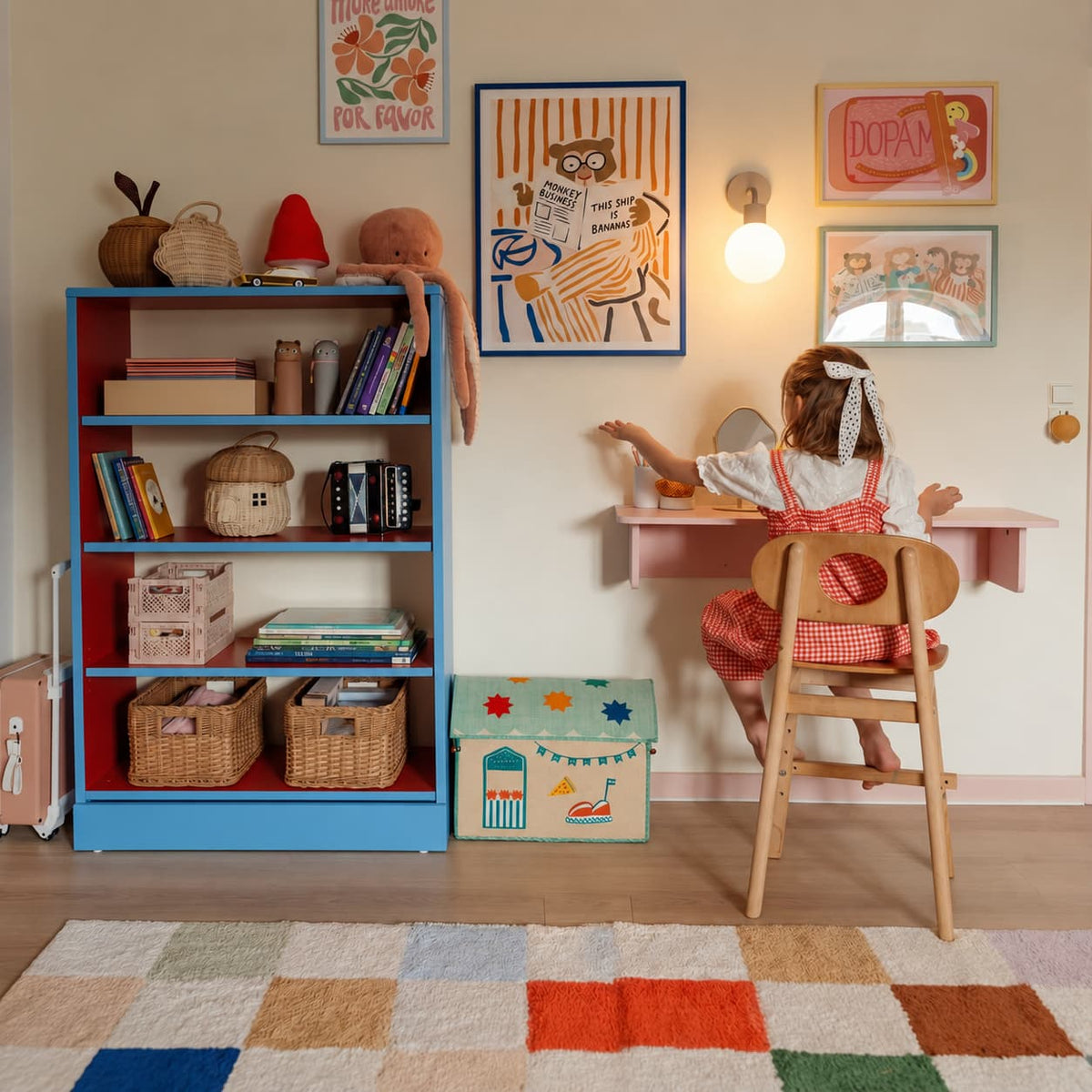 A little girl on her study table with blue cabinet and some framed wall arts with mushroom rechargeable wall light sconce
