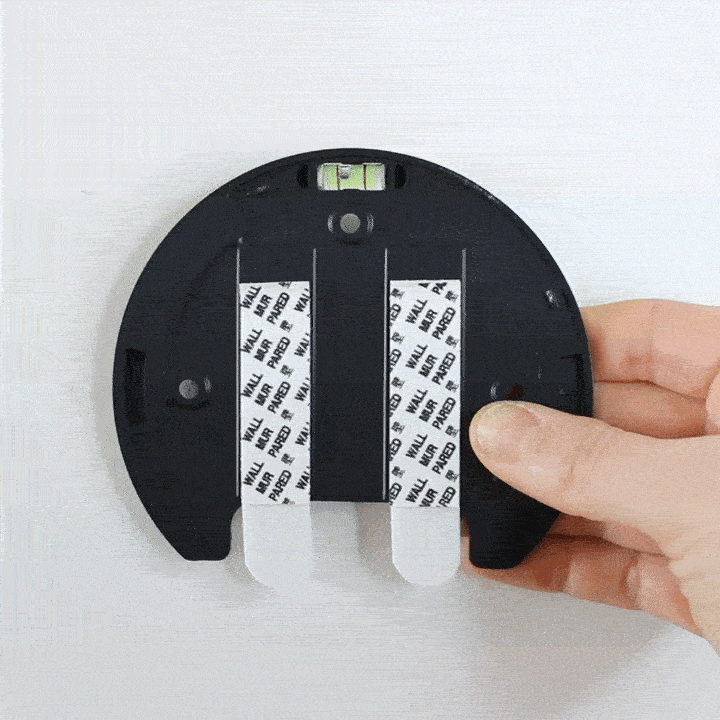 Peel off adhesive strip from the base of the wall light