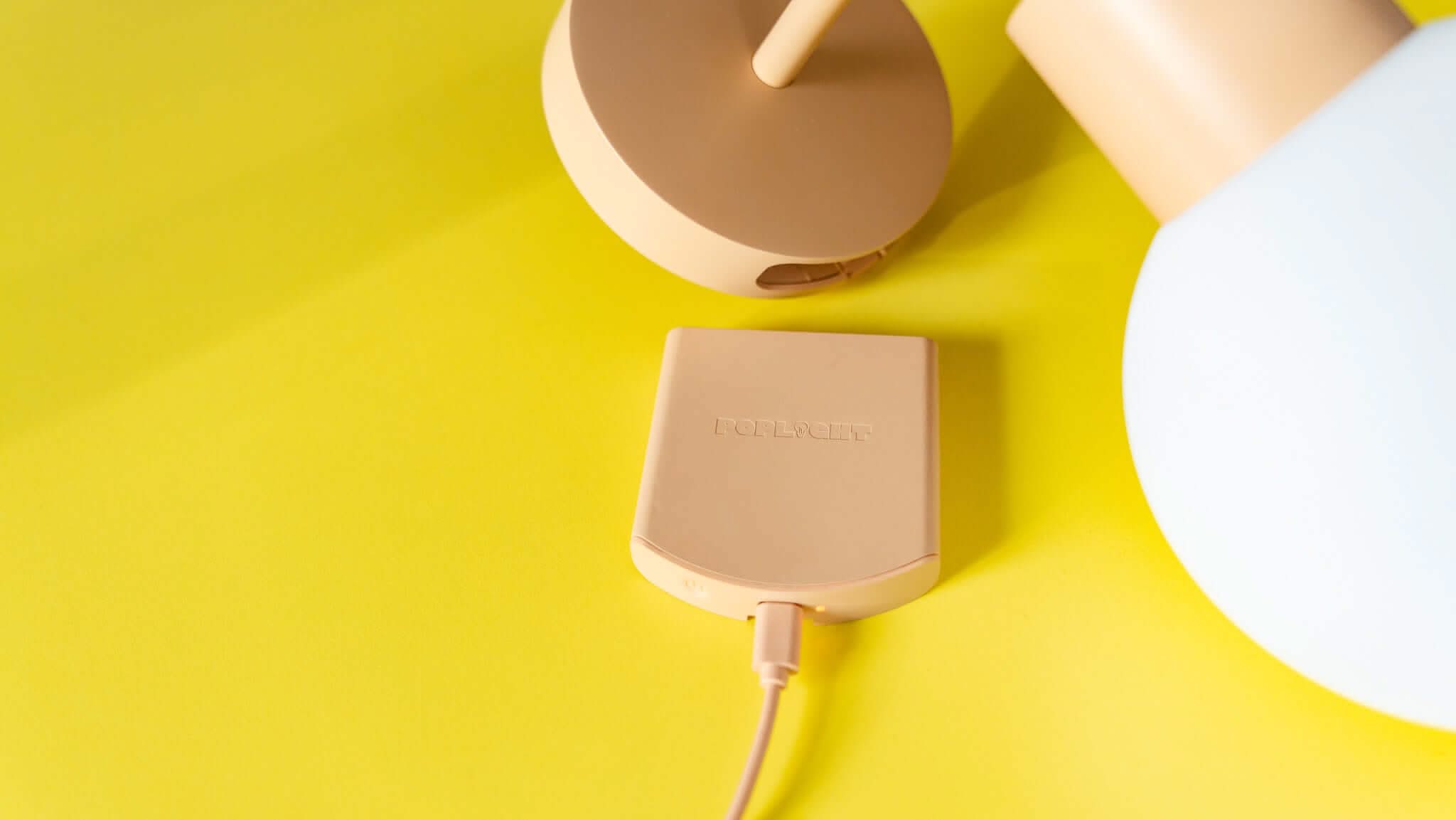 Poplight mushroom mounted in a yellow wall with battery.