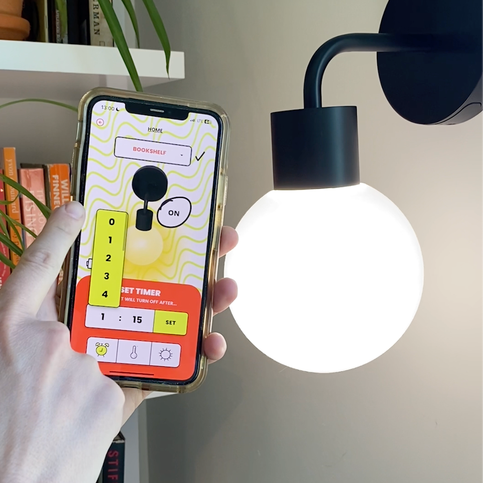 Person using a smartphone app to control a modern lamp with a timer feature.