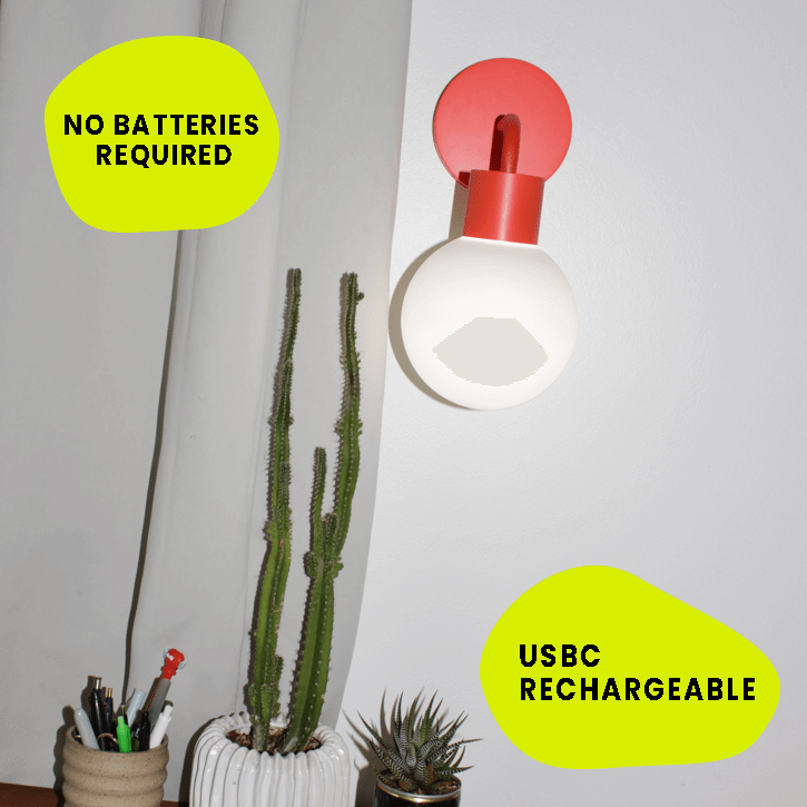 USBC rechargeable Vermillion Red Poplight stick-on wall light sconce, easily installed with no batteries required, near indoor plants.