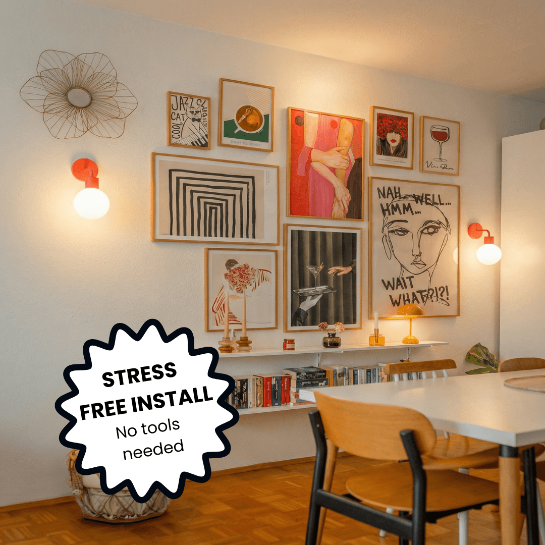 Dining room with gallery wall of framed art prints, white floating shelves, and illuminated with Poplight Vermillion Red wall light sconces.