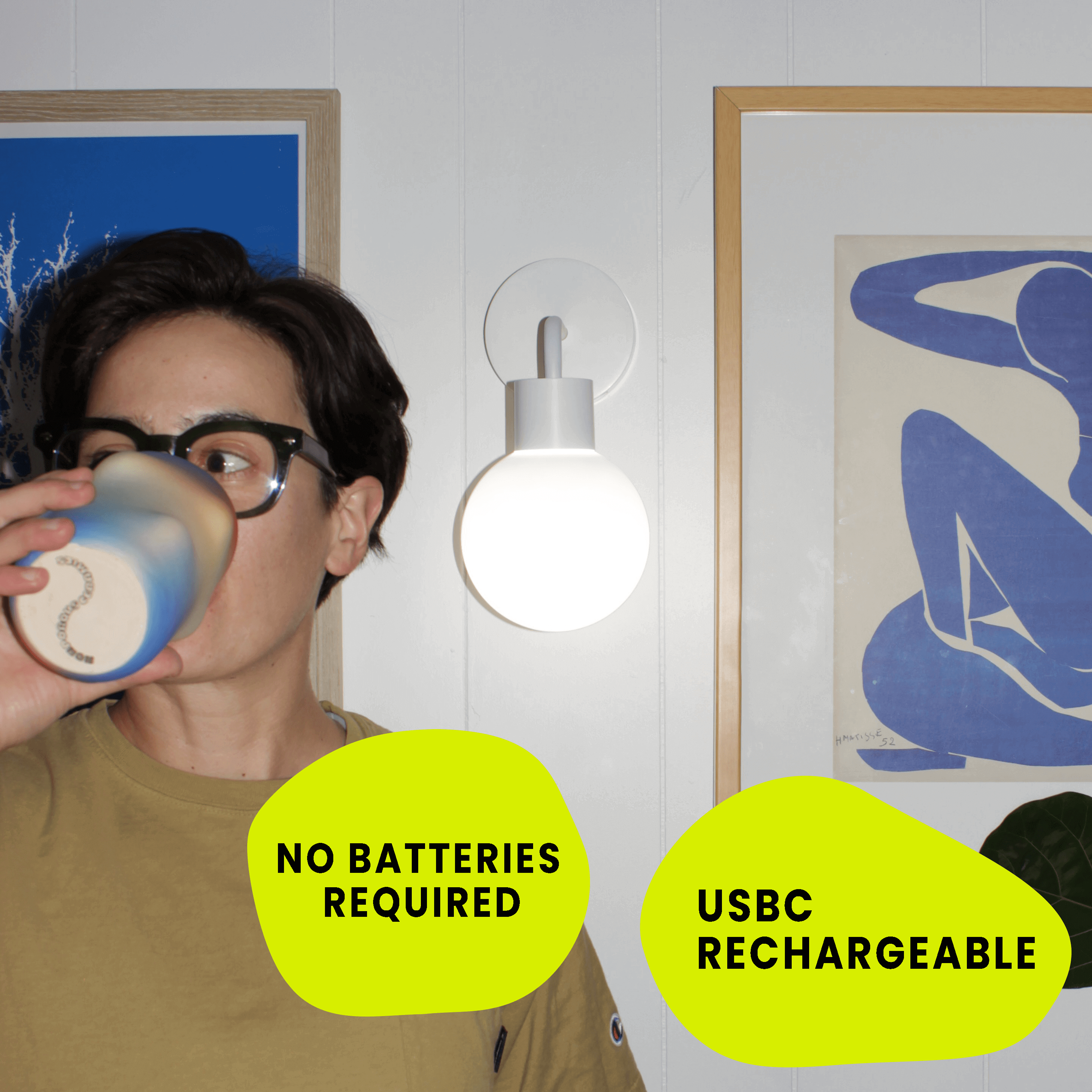 Person next to a wall-mounted rechargeable light with text: No batteries required, USB-C rechargeable.