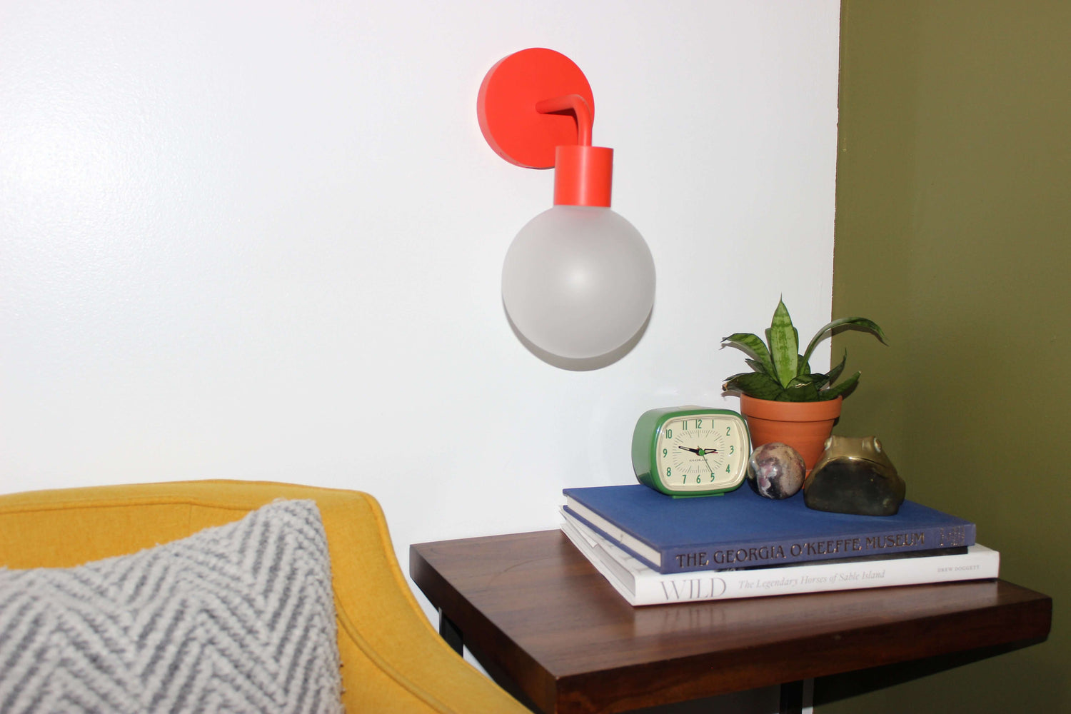 Vermillion red wall light sconce in a small office corner table
