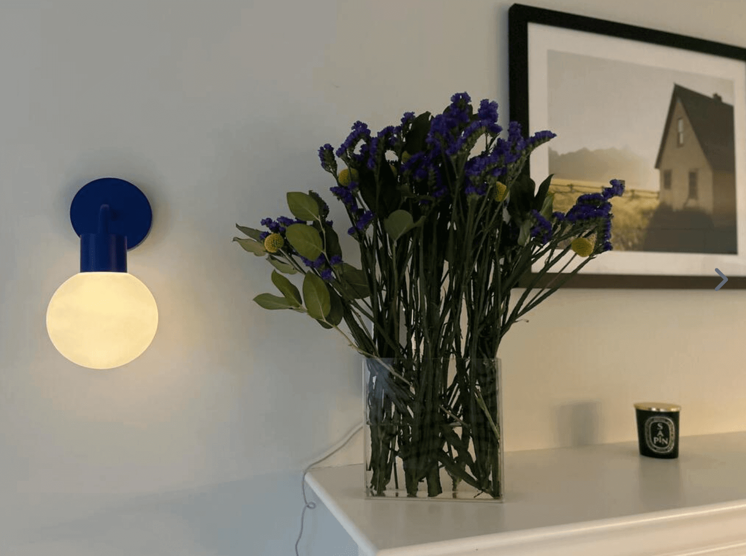 Warm light ambient from blue Poplight with a vase of flowers