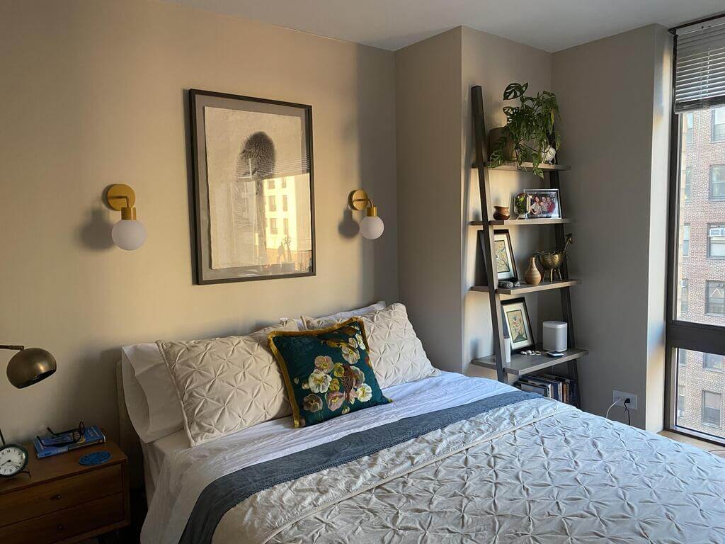 Apartment bedroom with modern marigold rechargeable wall sconces