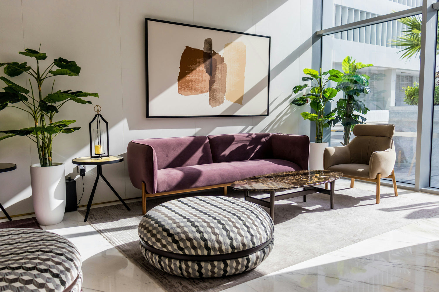 Apartment living room with indoor plants, long sofa and a round single accent chair