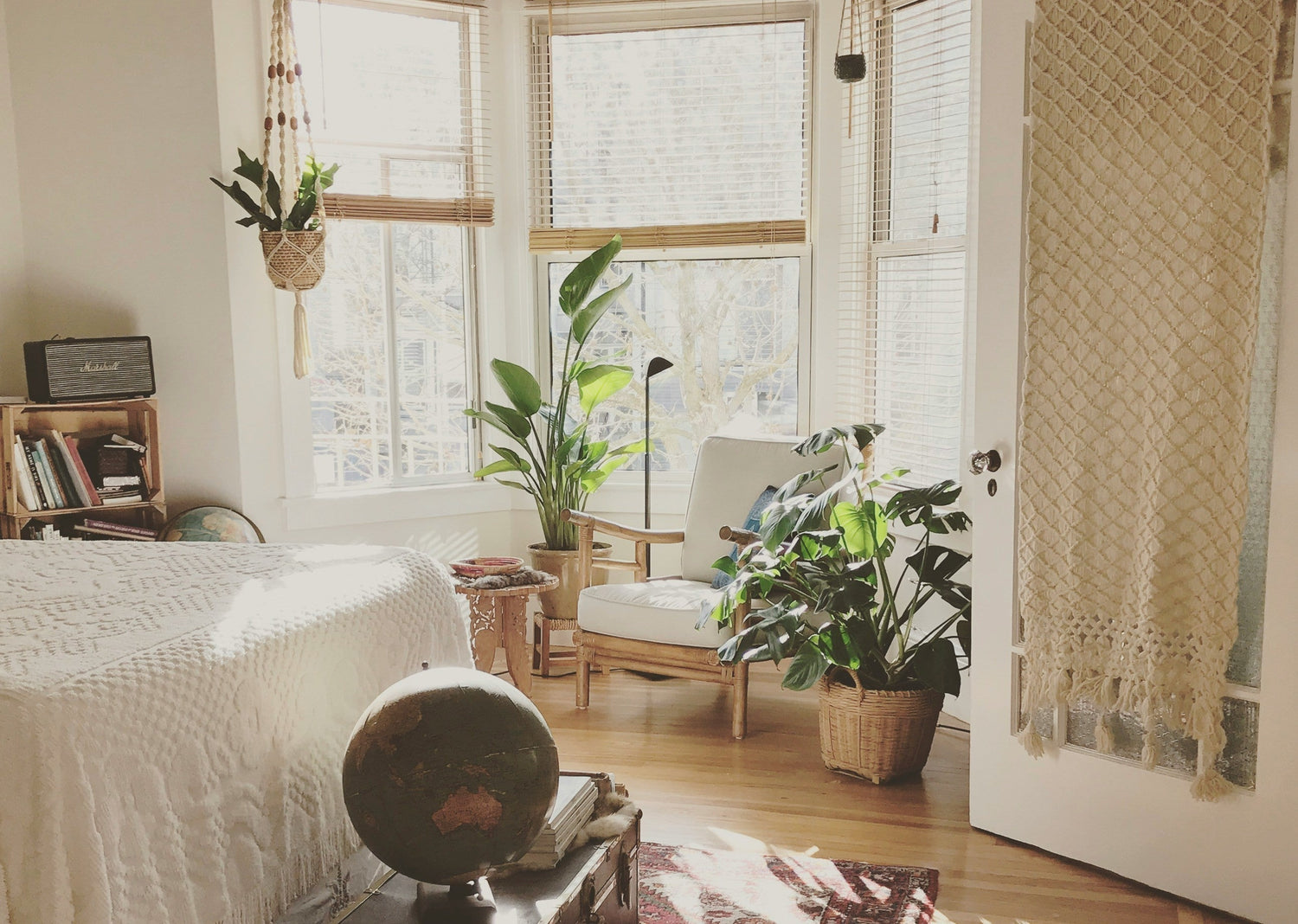Cozy apartment bedroom with natural warm lighting and indoor plants