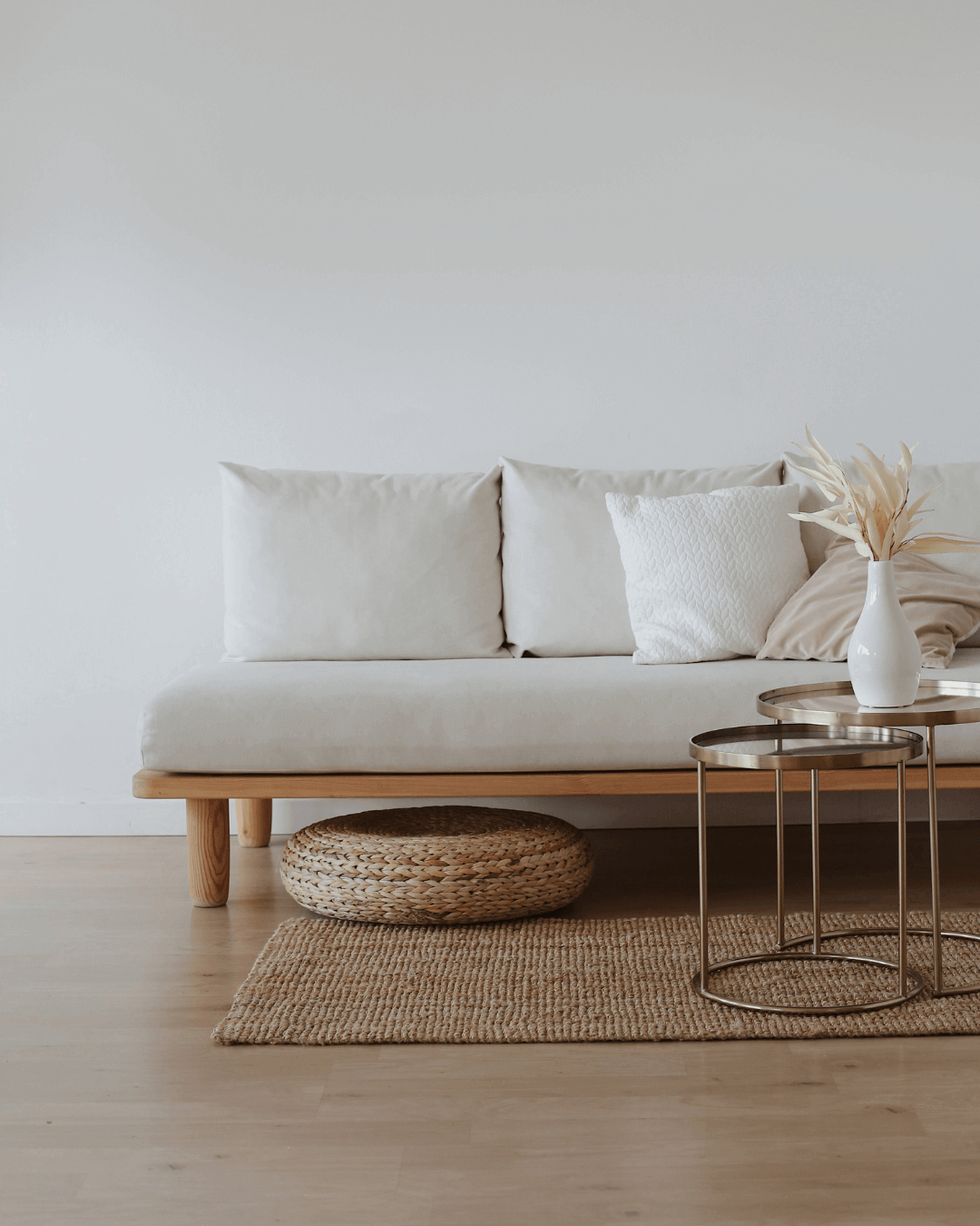 Apartment living room with white wall, a white sofa and a center table