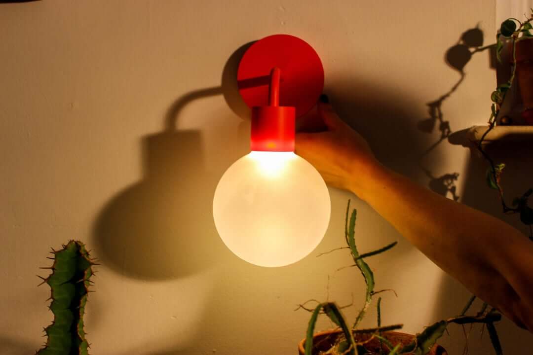 Warm light ambience from poplight vermillion red rechargeable sconce