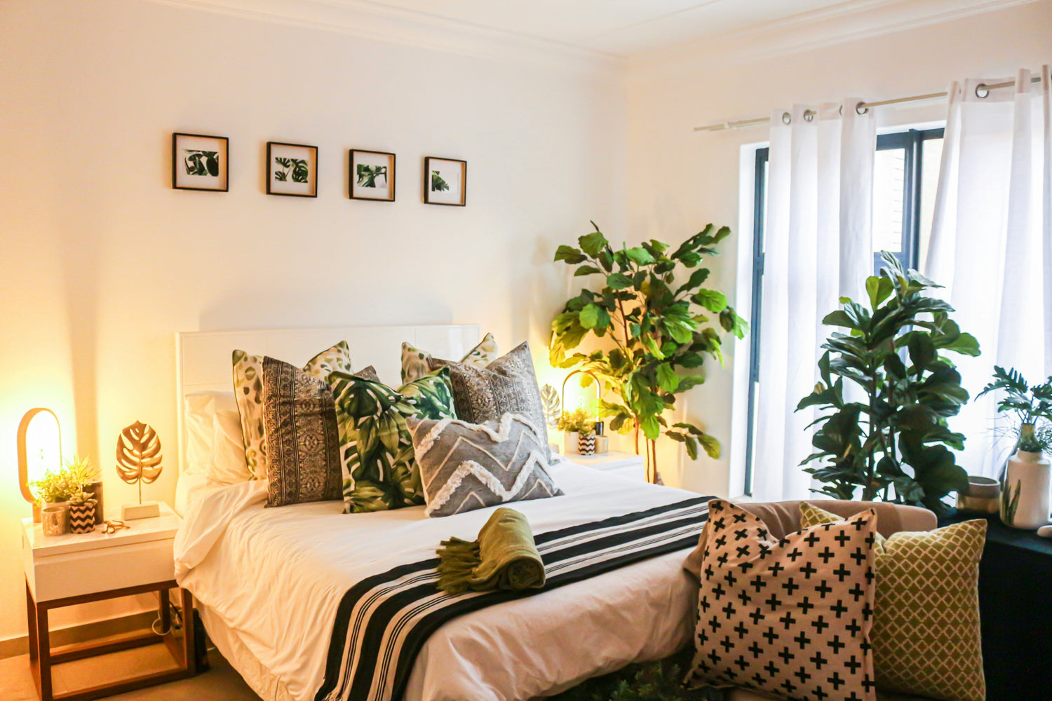 Warm lighted bedroom with soft textures pillow cases and indoor plants