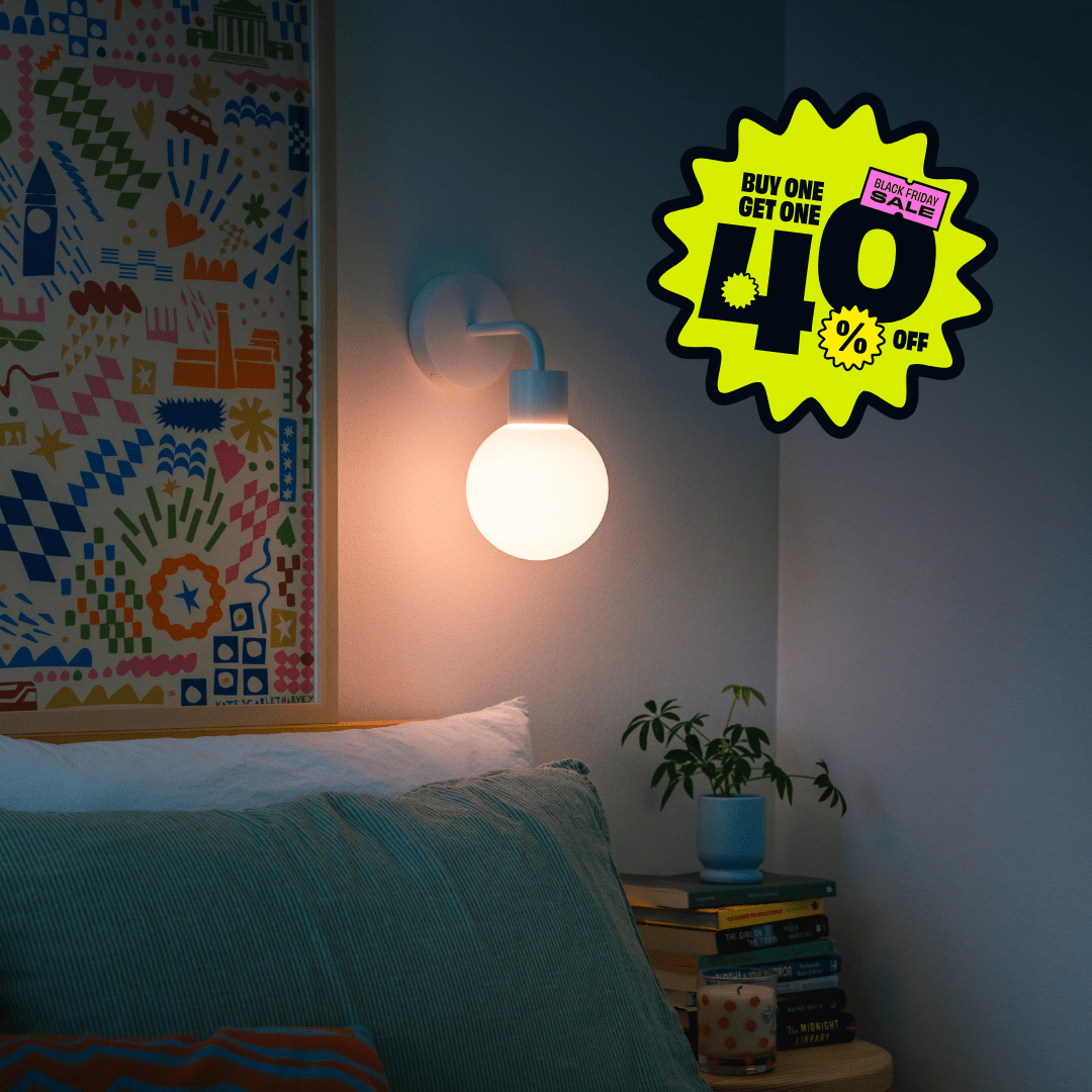 white rechargeable wall light in a cozy bedroom warm lighting