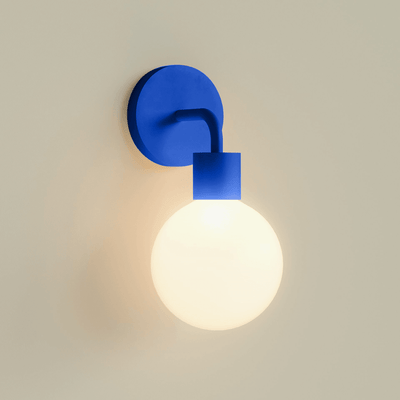 A single Blue Poplight illuminated against a beige wall