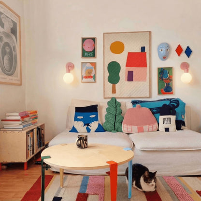 Kids bedroom with a cat sitting on the floor and two dusty rose rechargeable wall light sconces