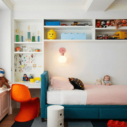 Kids bedroom with colorful toys on the cabinets and one dusty rose rechargeable wall light sconce