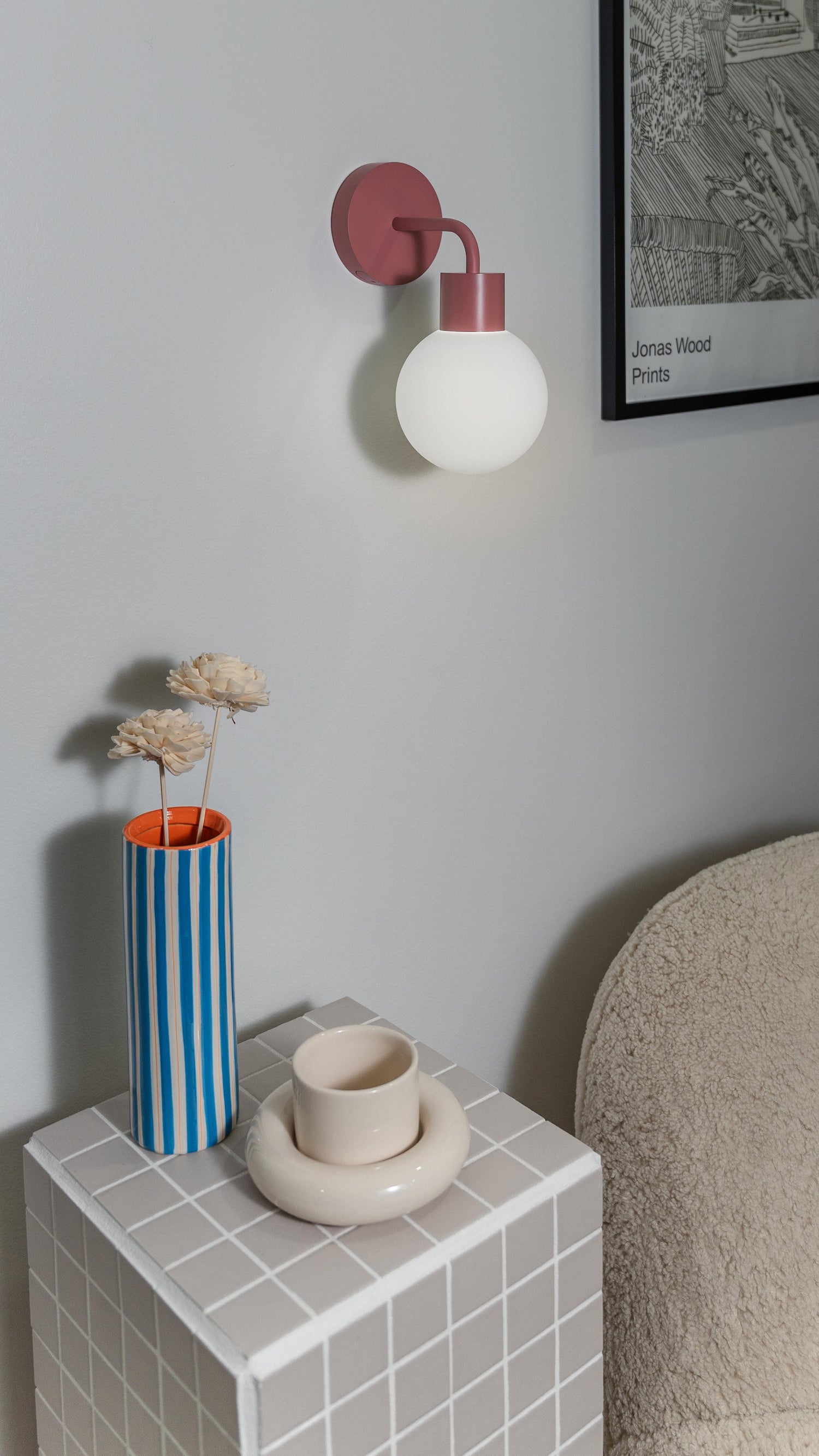 Modern rechargeable wall sconce with globe design illuminating a stylish interior space, enhancing decor and ambiance.