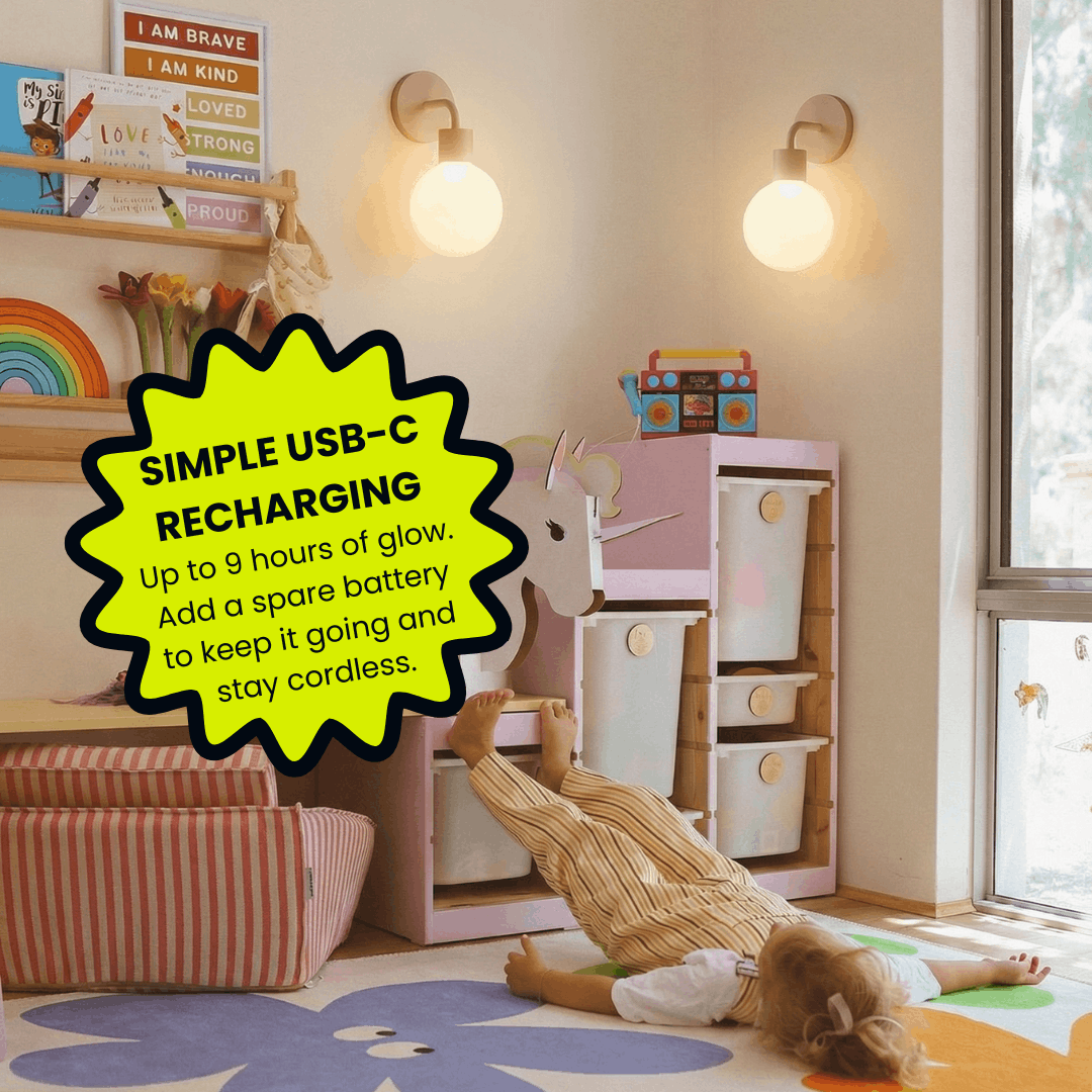 Child playing in nursery room with pink toy kitchen, wooden shelves, PL wall light sconces, and promotional text about USB-C rechargeable lighting.