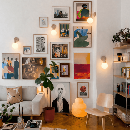 Living room with a wall of framed artwork, a sofa, and a chair.