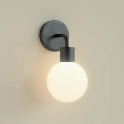 A single Black Poplight illuminated against a beige wall