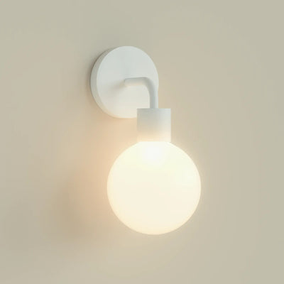 A single White Poplight illuminated against a beige wall