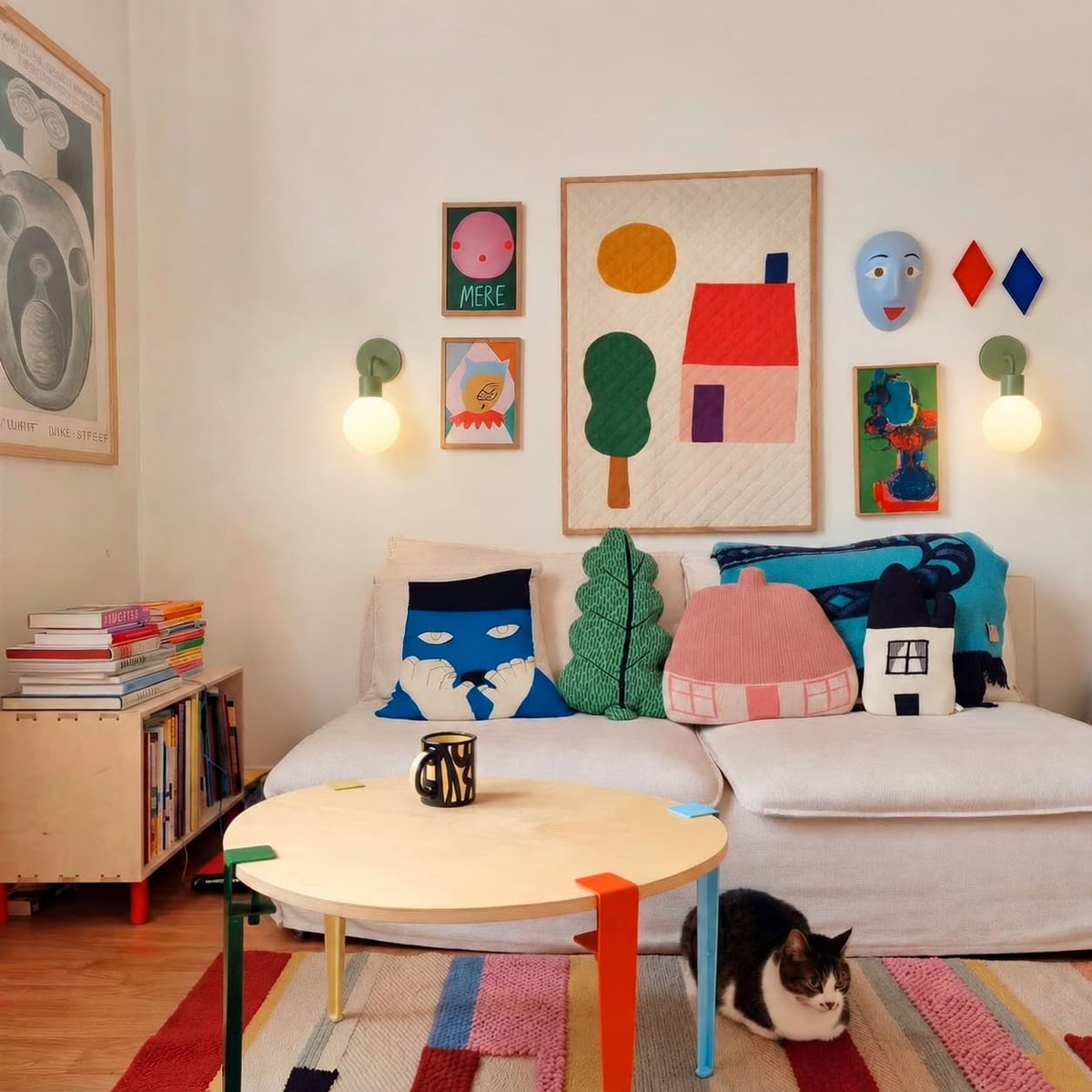 Kids room with colorful art pieces on the wall and two sage green rechargeable wall light sconces