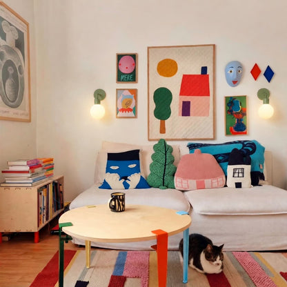 Kids room with colorful art pieces on the wall and two sage green rechargeable wall light sconces
