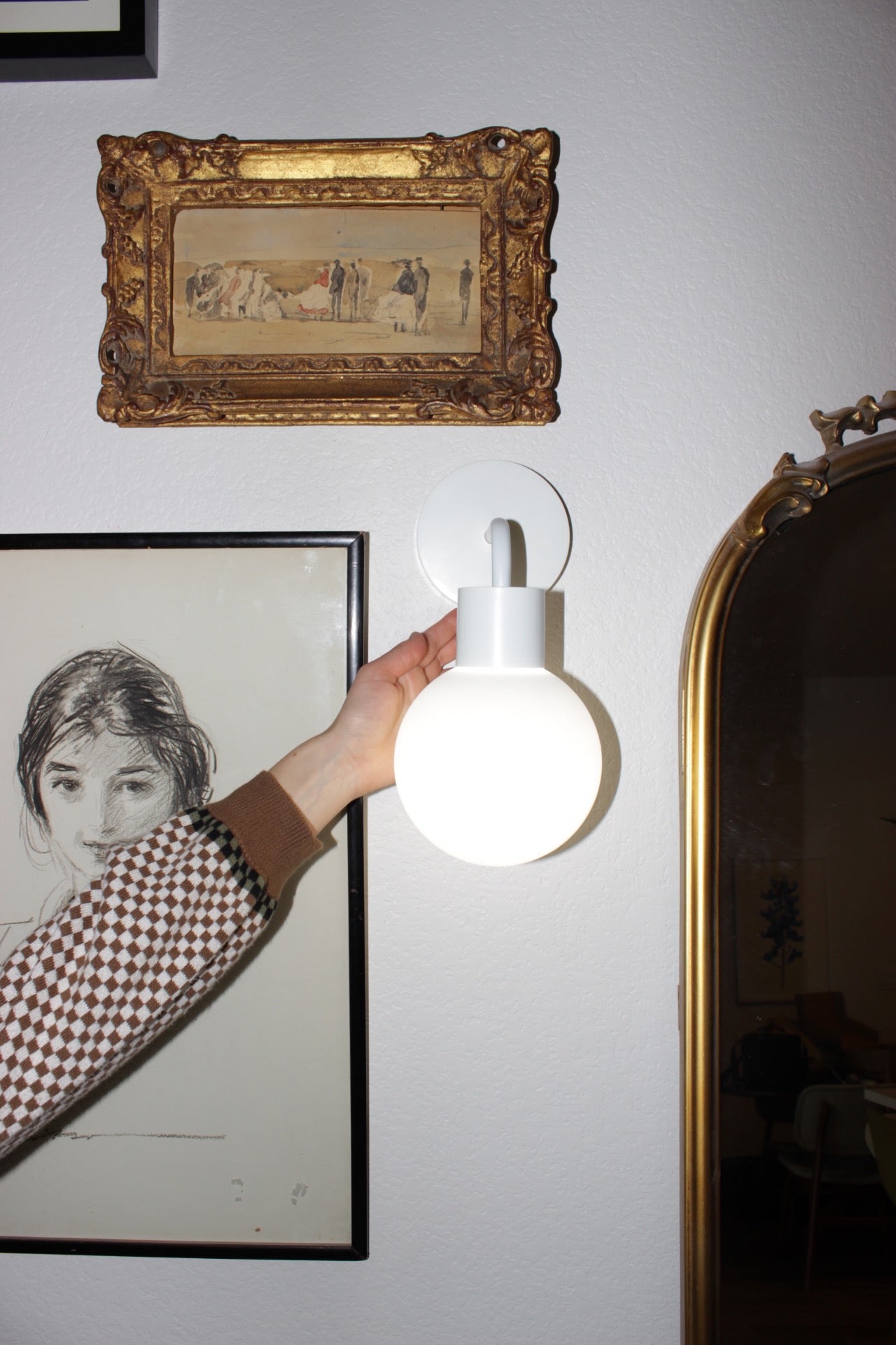 Stick-on wall sconce iin white that enhances the wall decor into chic and modern design