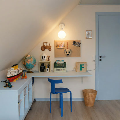 Kids spae with blue chair accent and a white rechargeable wall light sconce