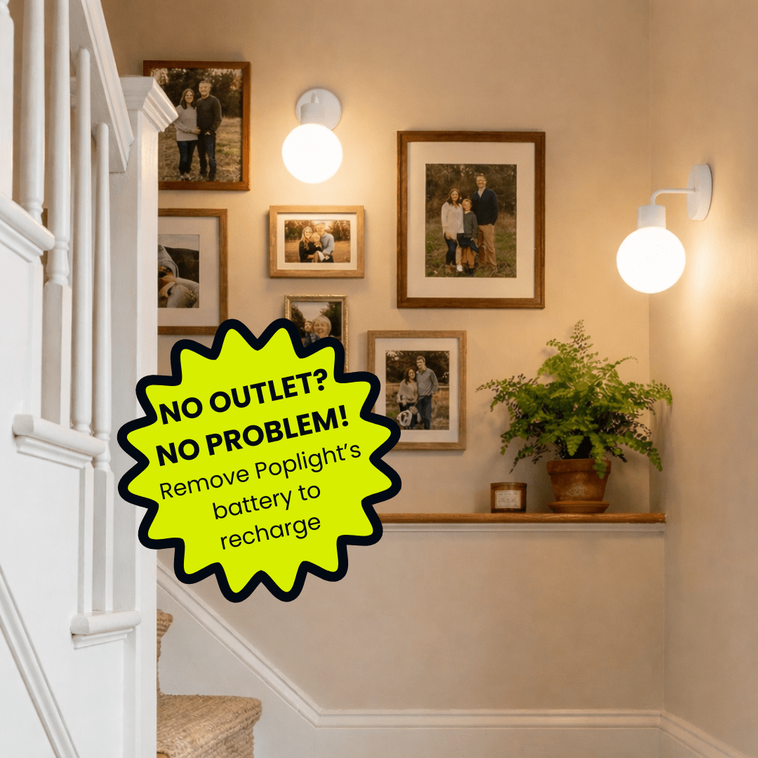 Stairway wall with gallery of framed family photos, Poplight White wall sconces, floating wooden shelf with potted plant