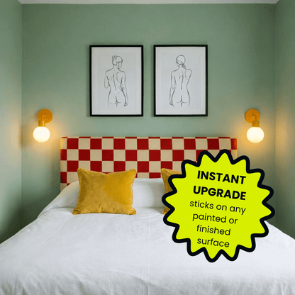 Bedroom with sage green walls, red and checkered headboard, yellow pillow, Poplight marigold rechargeable wall lights, and line art prints above bed.