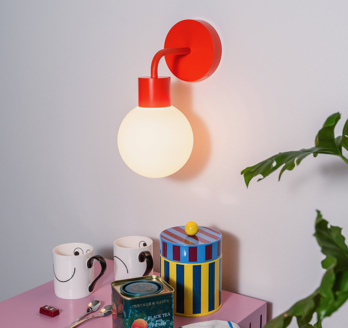 Warm light ambience from Vermillion red Poplight mounted on top of a coffee corner.